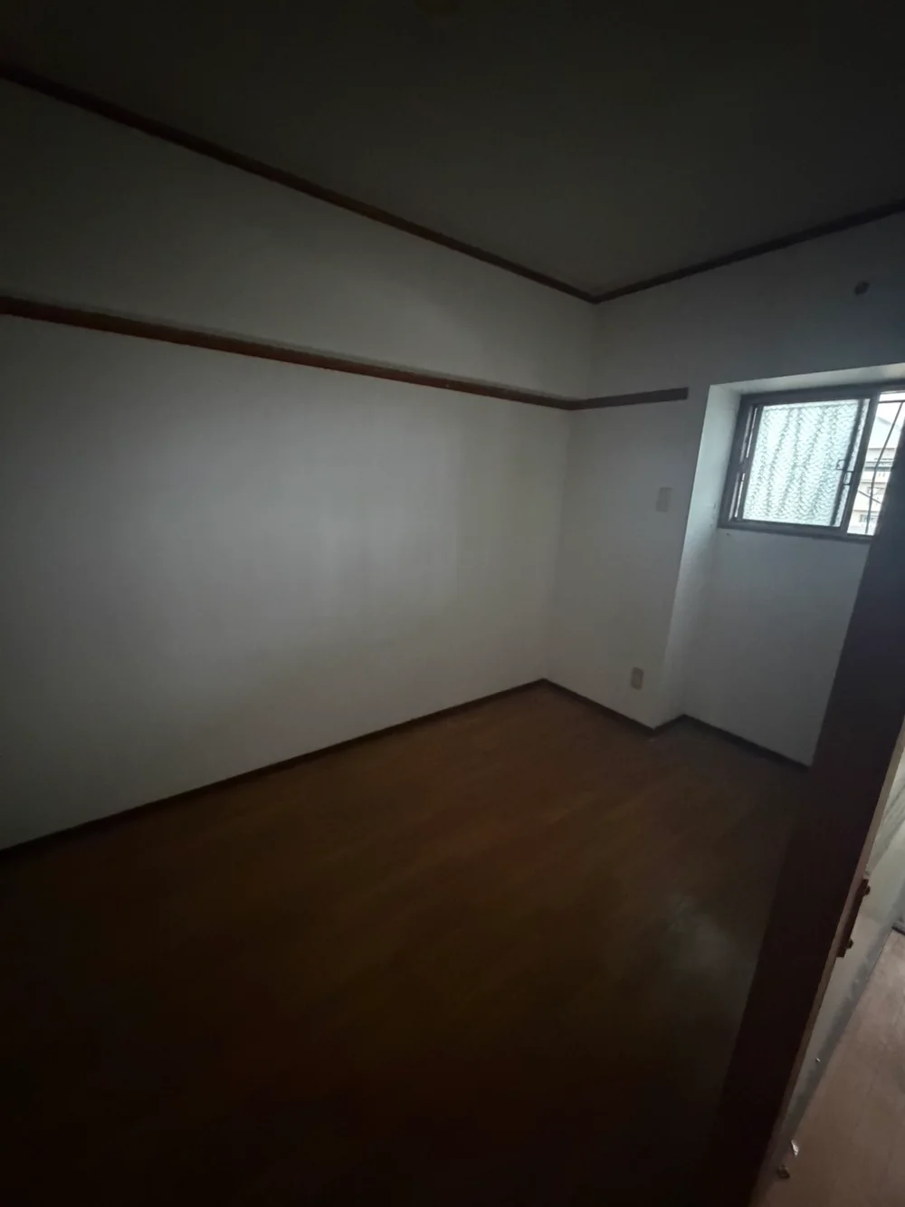 福岡県のゴミ屋敷片付け・汚部屋片付け | 九州片付け隊 福岡市の3LDKの同じ一室から家具と家財を搬出し、床と壁際が見えるようになった状態